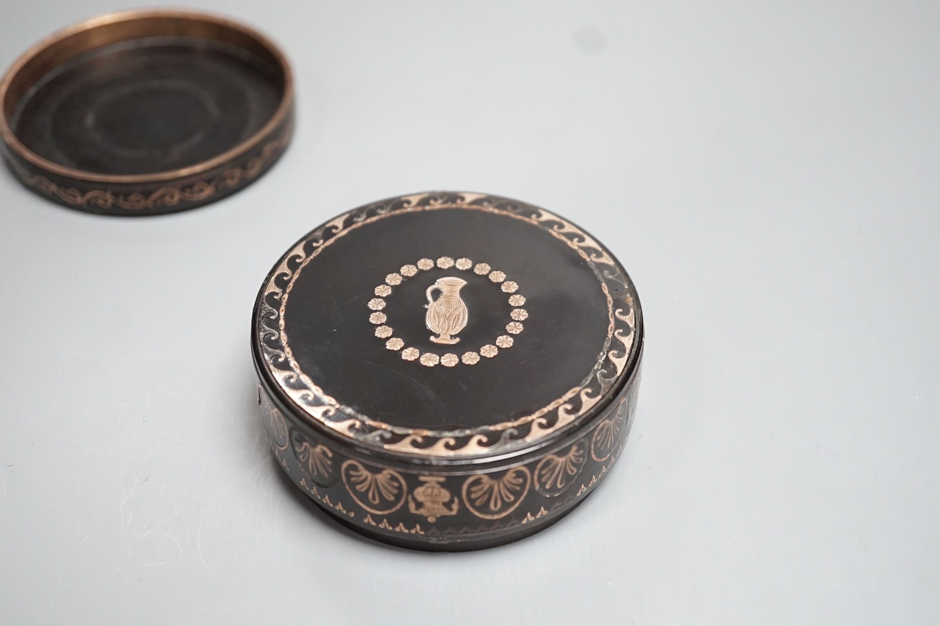 A 19th century yellow metal inlaid circular box and cover 8cm diameter